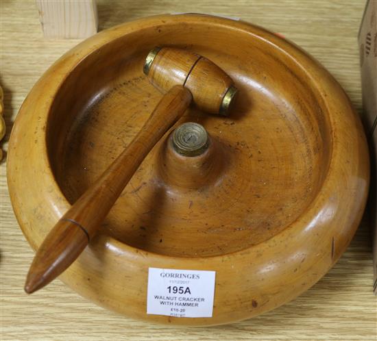 A large round wooden walnut nutcracker with hammer
